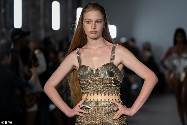 Backstage on Monday night, gushing admirers pass by, grabbing her arm and professing their love. On the catwalk, she received raucous applause and cheers as she inched down the runway in a constrictive, chain-link dress and white stilettos