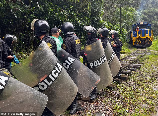 About 1,200 Machu Picchu tourists had to be evacuated in January 2024 due to protests over a new ticket sales system (pictured: police on the tracks during a January 2024 protest)