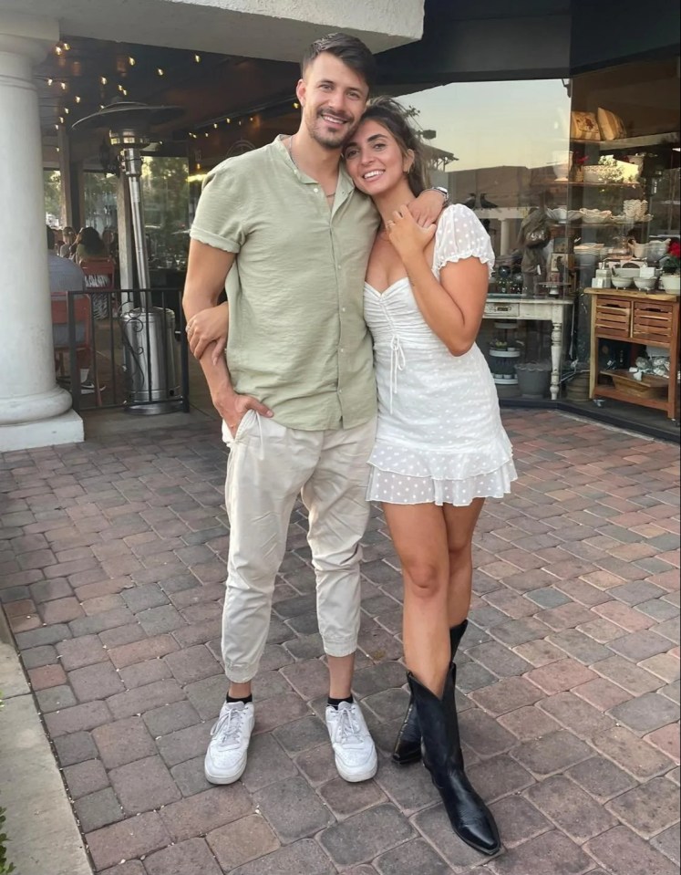 Emily Robbie and her husband Tyler standing outdoors.