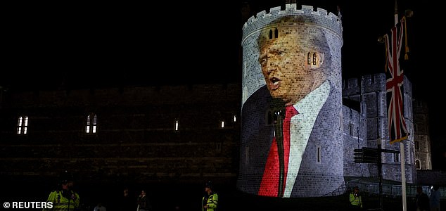 An image of U.S. President Donald Trump is projected by by the campaign group Led By Donkeys on Windsor castle, after the arrival of U.S. President Donald Trump and first lady Melania Trump for a state visit to the country, in Windsor, Berkshire, Britain September 16, 2025. REUTERS/Phil Noble
