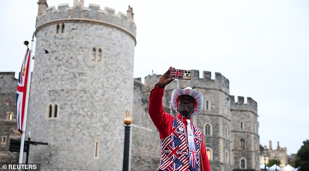 A man in a Union Jack suit takes a selfie outside Windsor Castle ahead of Trump's arrival, in Windsor, Britain, September 17, 2025. REUTERS/Phil Noble
