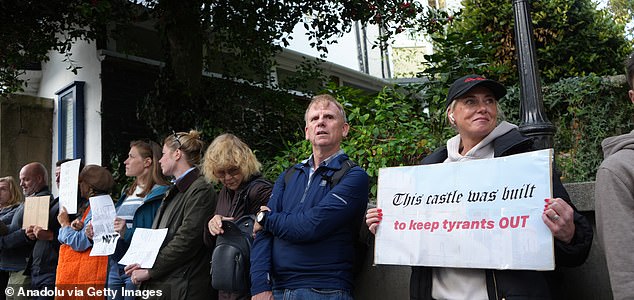 WINDSOR, UNITED KINGDOM - SEPTEMBER 16: Hundreds of protesters gather on Windsor High Street near the castle to oppose US President Donald Trump's arrival in the UK on September 16, 2025 in Windsor, United Kingdom. The demonstrators carried banners, chanted slogans against Trump's policies saying "Trump out!" and marched through the streets. US President Donald Trump is paying three-day state visit to the UK, following an invitation extended by King Charles in February during Prime Minister Keir Starmer's visit to Washington, DC. (Photo by Yunus Dalgic/Anadolu via Getty Images)