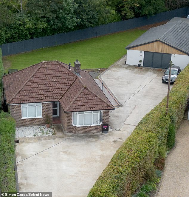 Glen won approval to build the detached garage (pictured behind his house) on a plot of land to the rear of his home in 2019, which he later turned into a modern gym