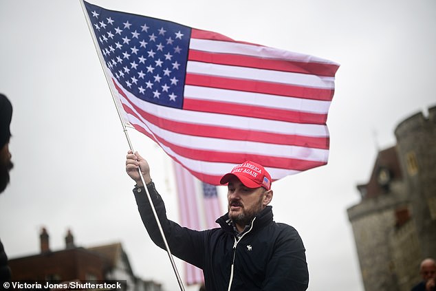 A supporter of US President Donald Trump stands outside Windsor Castle this morning