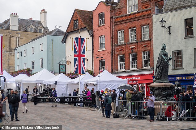Members of the media stand outside Windsor Castle this morning to cover the state visit
