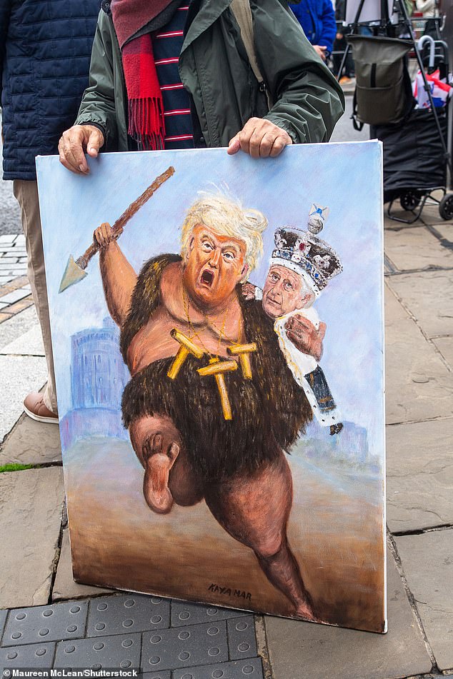 Artist Kaya Mar holds a painting depicting Donald Trump and King Charles in Windsor today