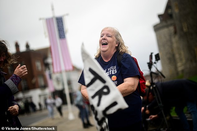 A supporter of US President Donald Trump stands outside Windsor Castle this morning