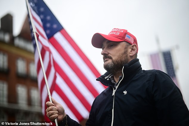 A supporter of US President Donald Trump stands outside Windsor Castle this morning