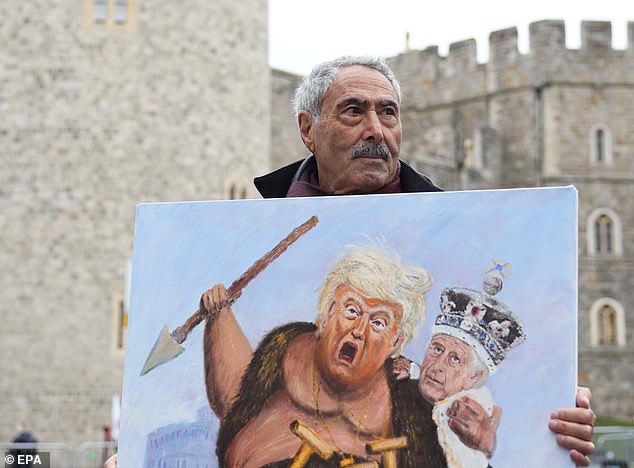 Artist Kaya Mar holds a painting depicting Donald Trump and King Charles in Windsor today