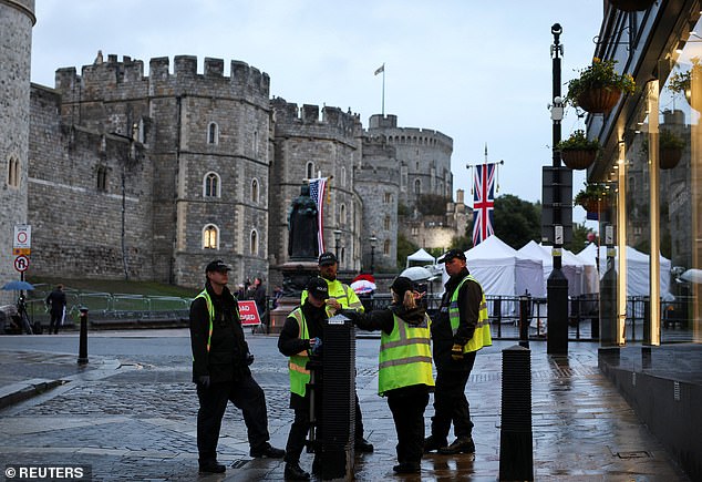A security team stand on duty outside Windsor Castle this morning as the state visit begins