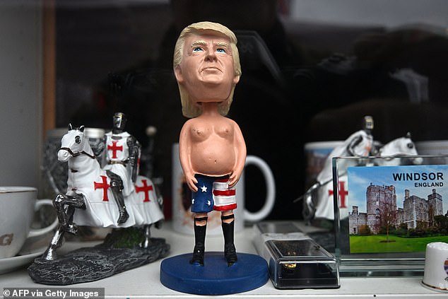 A figurine of Donald Trump is displayed for sale in the window of a shop in Windsor today