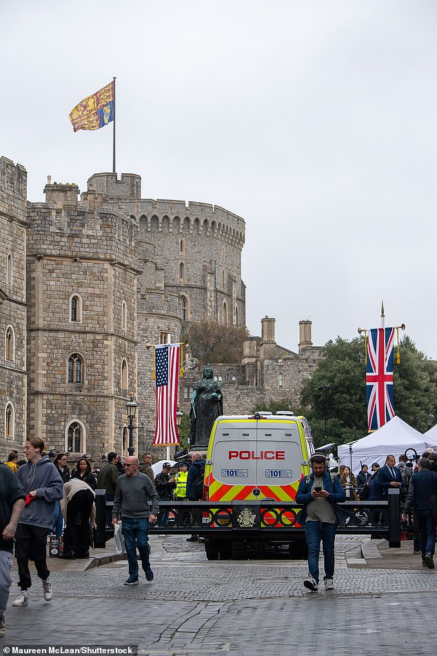 A gigantic royal standard is pictured flying from the Royal Tower of Windsor Castle today