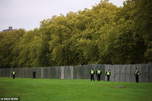 Police officers walk near Windsor Castle this morning as the state visit gets underway
