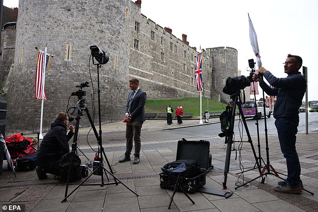 Members of the media stand outside Windsor Castle this morning to cover the state visit