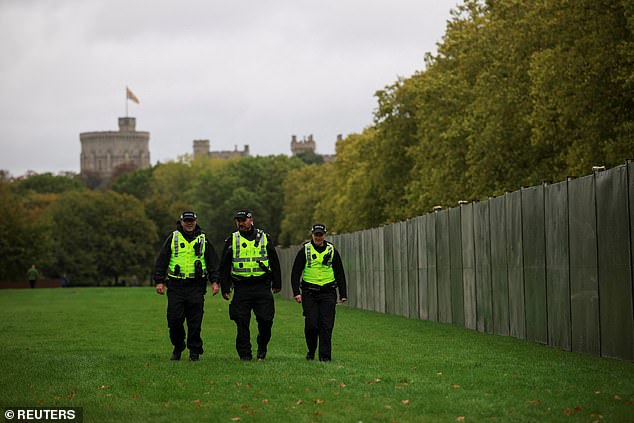 Police officers walk near Windsor Castle this morning as the state visit gets underway