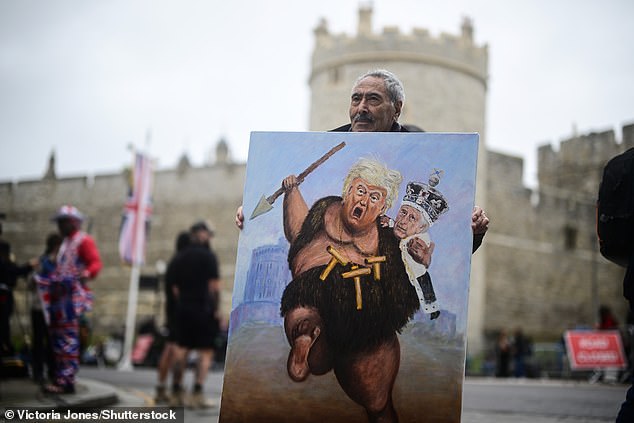 Artist Kaya Mar holds a painting depicting Donald Trump and King Charles in Windsor today