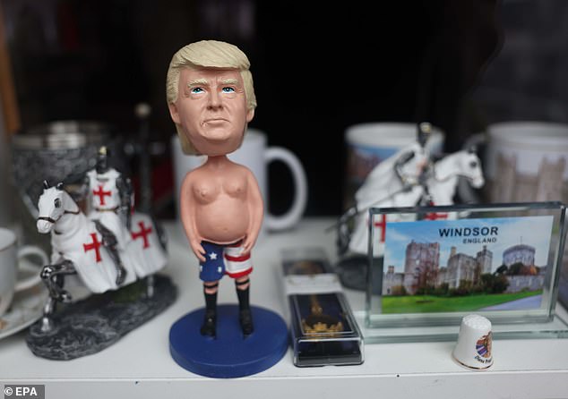 A figurine of Donald Trump is displayed for sale in the window of a shop in Windsor today