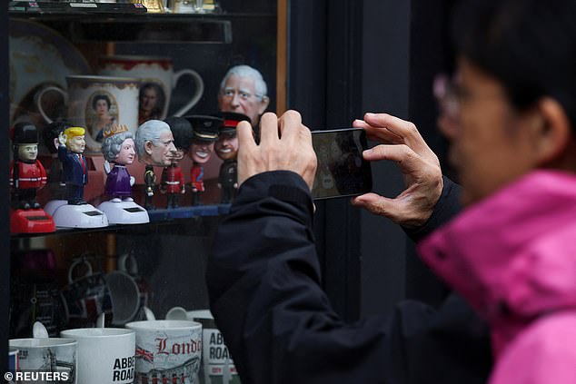 A figurine of Donald Trump is displayed for sale in the window of a shop in Windsor today