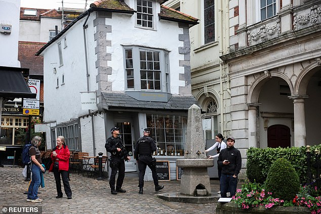 Police officers patrol in Windsor this morning as the state visit gets underway