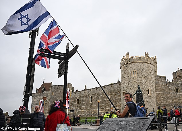 A person flies the flags of Israel and the United Kingdom outside Windsor Castle today