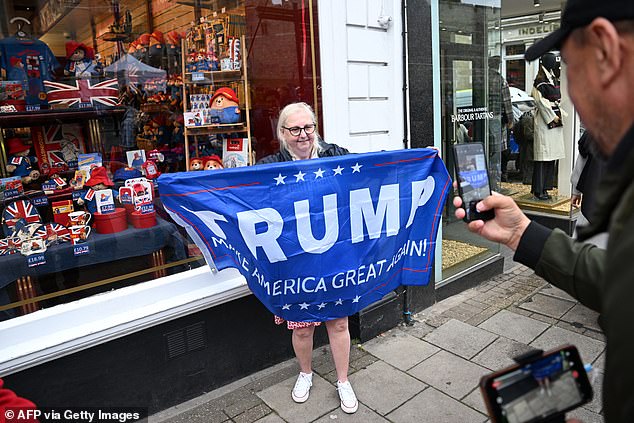 A supporter of US President Donald Trump stands outside Windsor Castle this morning