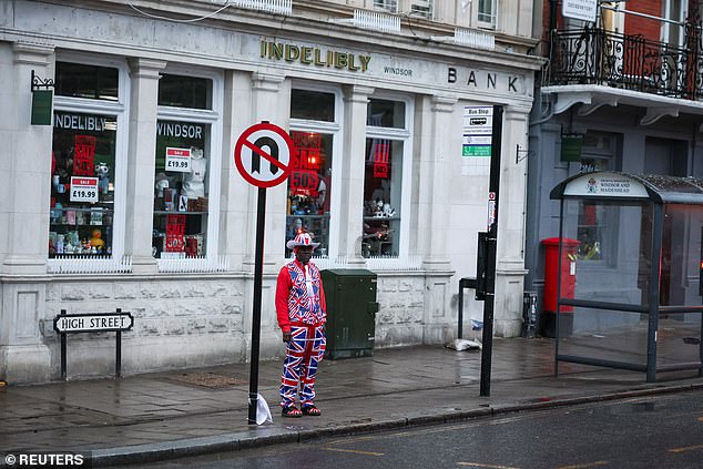 A man in a Union Jack suit stands outside a store in Windsor today as the state visit begins