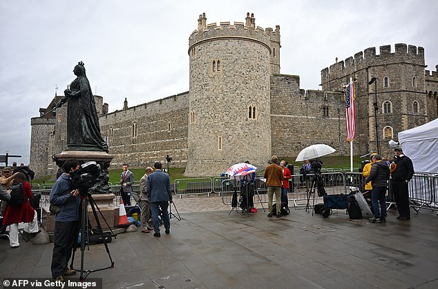 Members of the media stand outside Windsor Castle this morning to cover the state visit