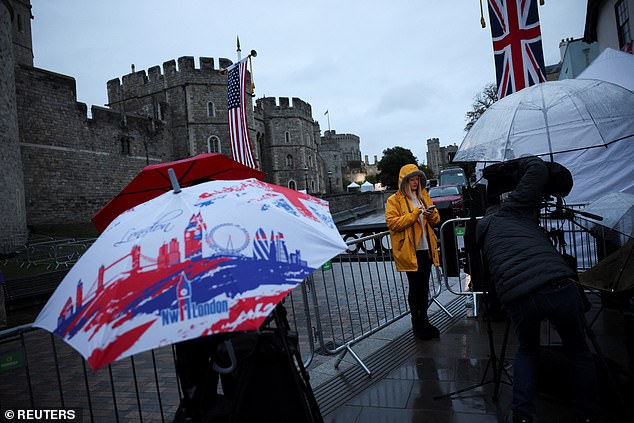 Members of the media stand outside Windsor Castle this morning to cover the state visit