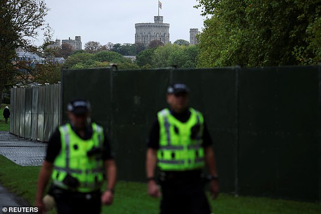 Police officers walk near Windsor Castle this morning as the state visit gets underway