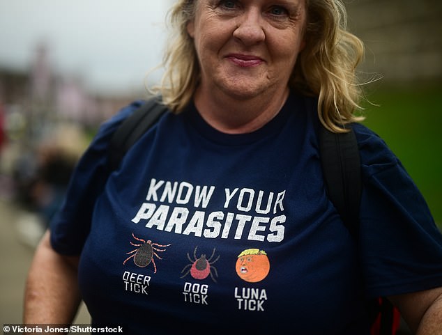 A protester displays her T-shirt outside Windsor Castle today as President Donald Trump visits