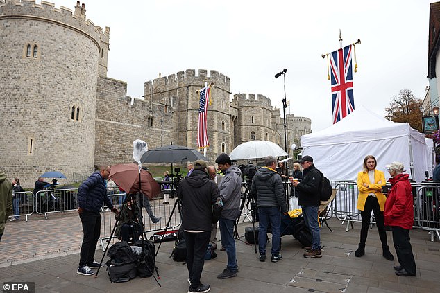 Members of the media stand outside Windsor Castle this morning to cover the state visit