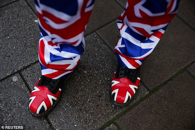 A royal fan is dressed in a Union Jack suit in Windsor today as the state visit gets underway