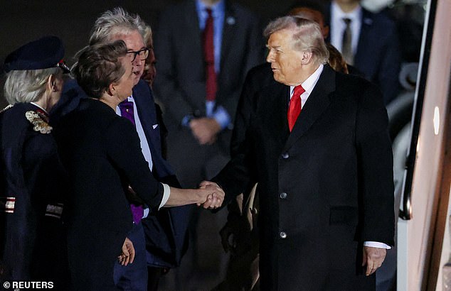 Donald Trump shakes hands with Foreign Secretary Yvette Cooper at Stansted last night