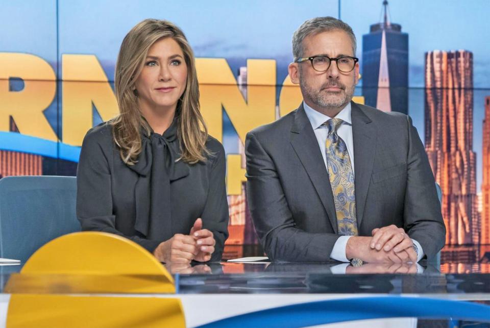Jennifer Aniston and Steve Carell at a news desk for The Morning Show.