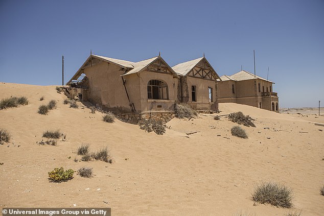 Explore the desolate ghost town of Kolmanskop that is slowly disappearing beneath the sand