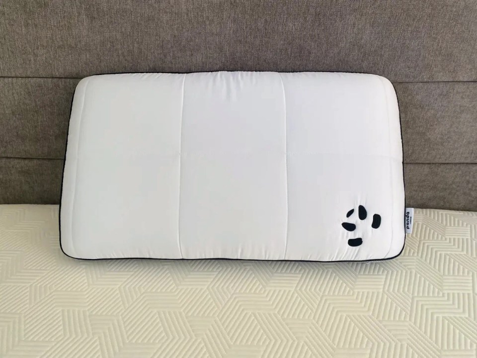 Panda Hybrid Bamboo pillow on a bed.