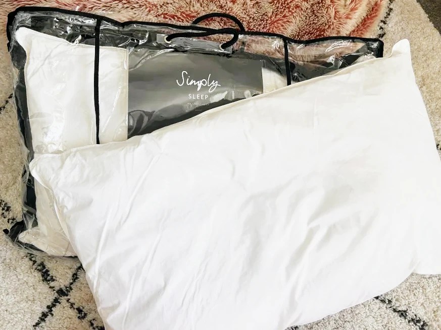 Two Simply Sleep classic duck feather pillows in a plastic package.