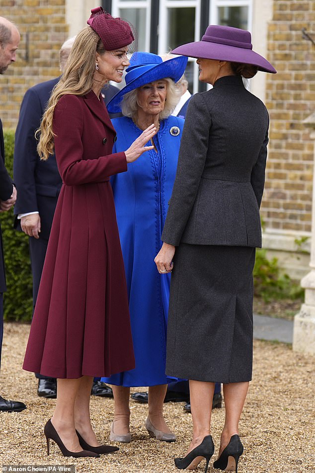 The Princess of Wales in conversation with Melania Trump, wearing all black, while Queen Camilla opted for a sapphire blue dress by Fiona Clare
