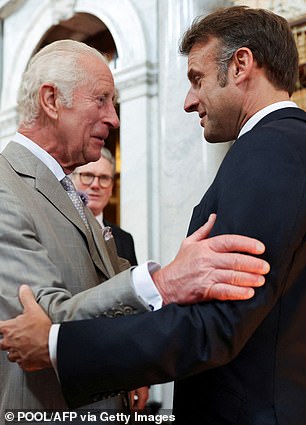 Pictured is the French President Macron warmly meeting the King in 2023