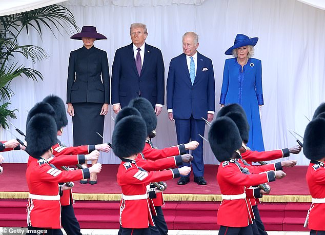 The two couples watch on as soldiers in bearskins march past them
