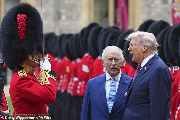 President Trump speaks with the King as he inspects a guard of honour
