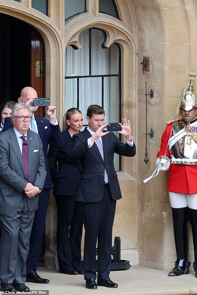UK Ambassador to the US, James Roscoe takes a picture ahead of the ceremonial welcome