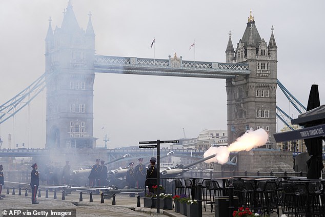 Members of the Honourable Artillery Company fire a 41-gun salute next to Tower Bridge today