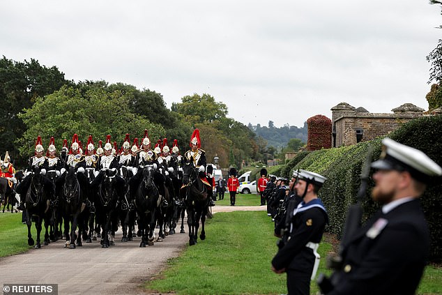 Members of the Household Cavalry Mounted Regiment form up ahead of the procession today