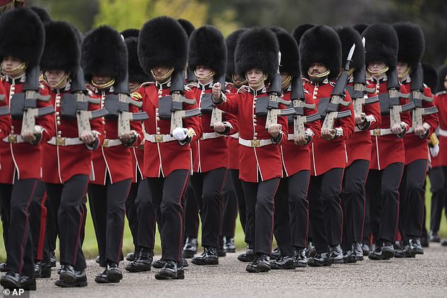 Members of the Household Division Foot Guards line up along the route in Windsor today