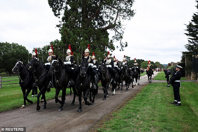 Members of the Household Cavalry Mounted Regiment form up ahead of the procession today