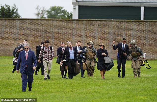 White House staff disembark from a helicopter ahead of the arrival of President Trump today
