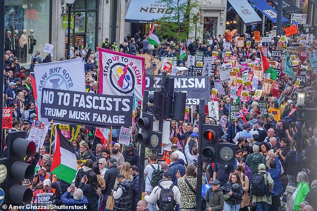 Thousands of protesters with signs and placards march through central London during President Trump's visit