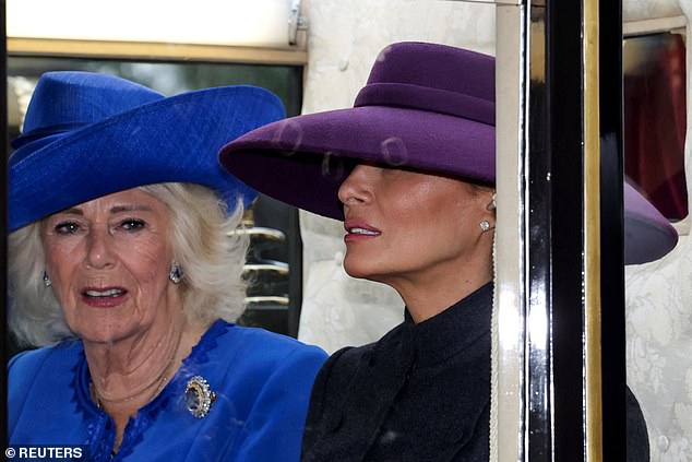 Britain's Queen Camilla and US first lady Melania Trump sit in a carriage during a procession through Windsor Castle. Melania looked effortlessly chic in a Christian Dior Haute Couture dark gray skirt suit that flared out at the waist and fell just below her knees