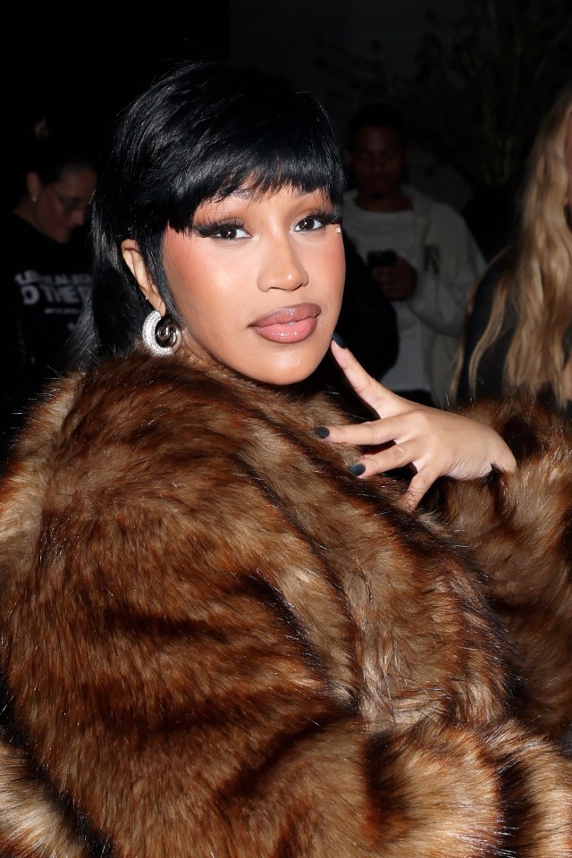 Cardi B attends the Alexander Wang show in a brown faux fur coat.